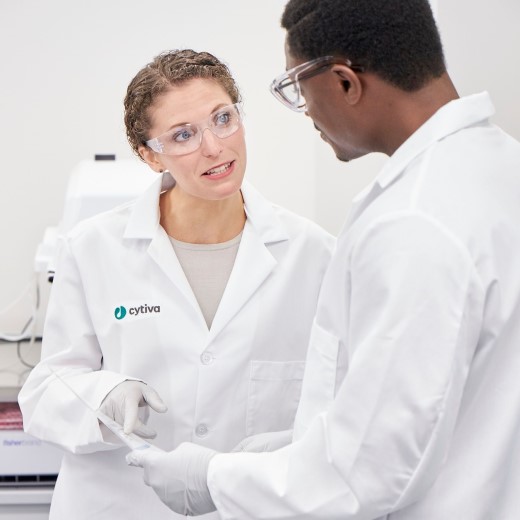 Two scientists in a cell therapy lab