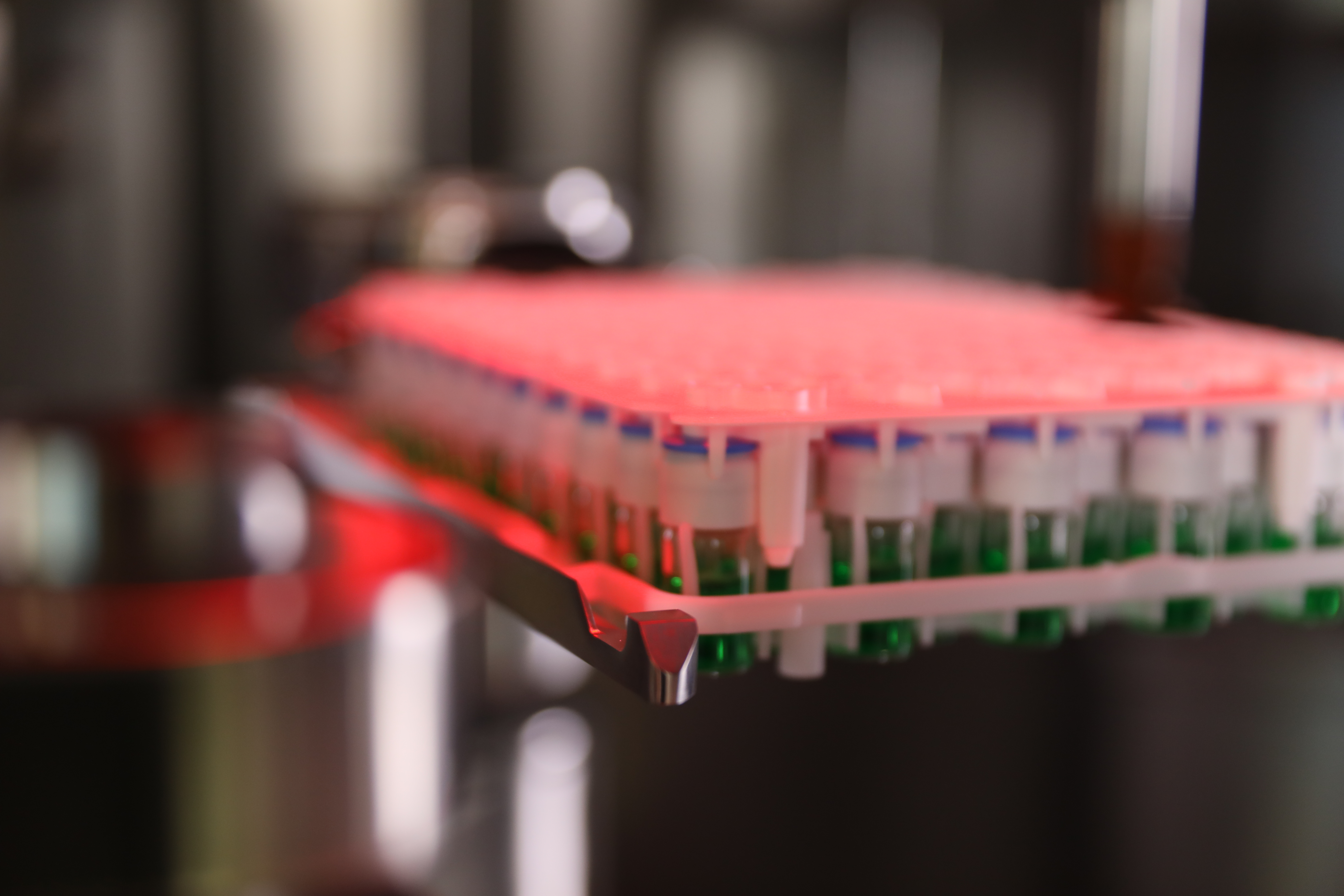 Close-up shot of vials moving through the SA25 Aseptic Filling Workcell