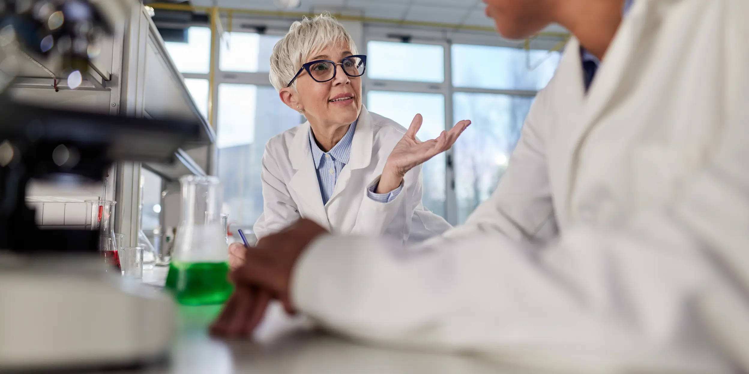 A Cytiva project manager talking with a scientist at their site