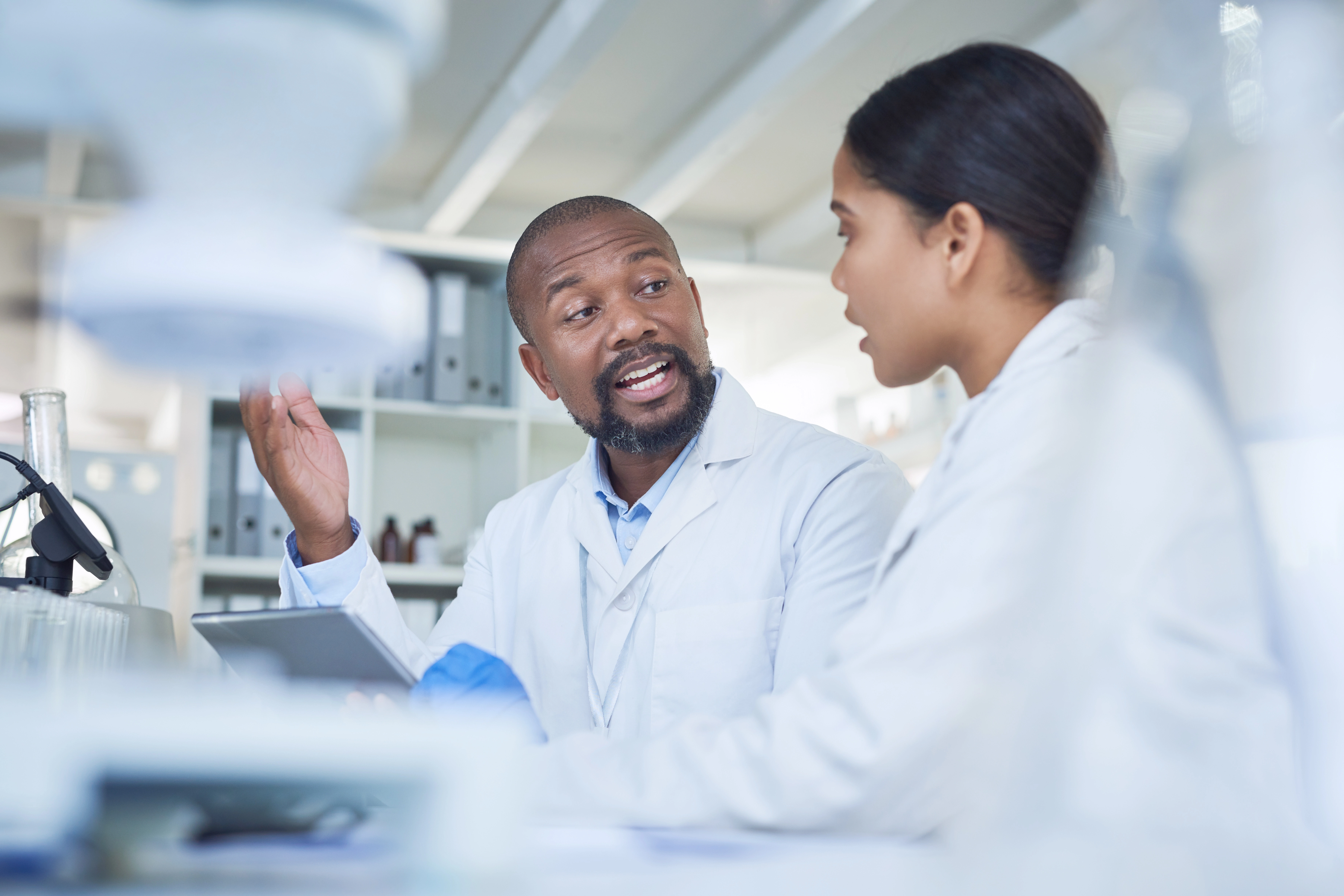 Scientists talking at the desk in the lab 