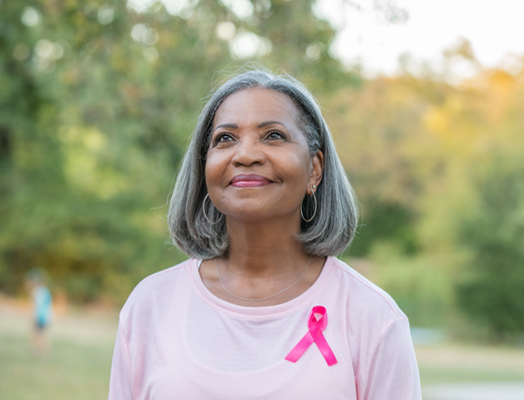 Senior woman fundraising for Breast Cancer Research Foundation during Breast Cancer Awareness Month
