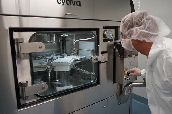 Operator observes vial filling process from outside the Cytiva Microcell Vial Filler