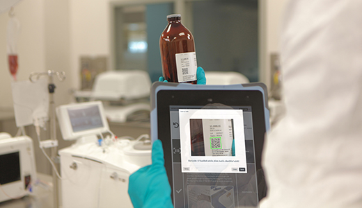 An operator scans a reagent label to identify lot number and expiration date.