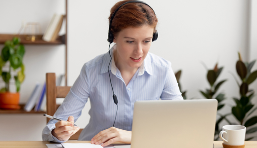 Business woman with headphones in webinar