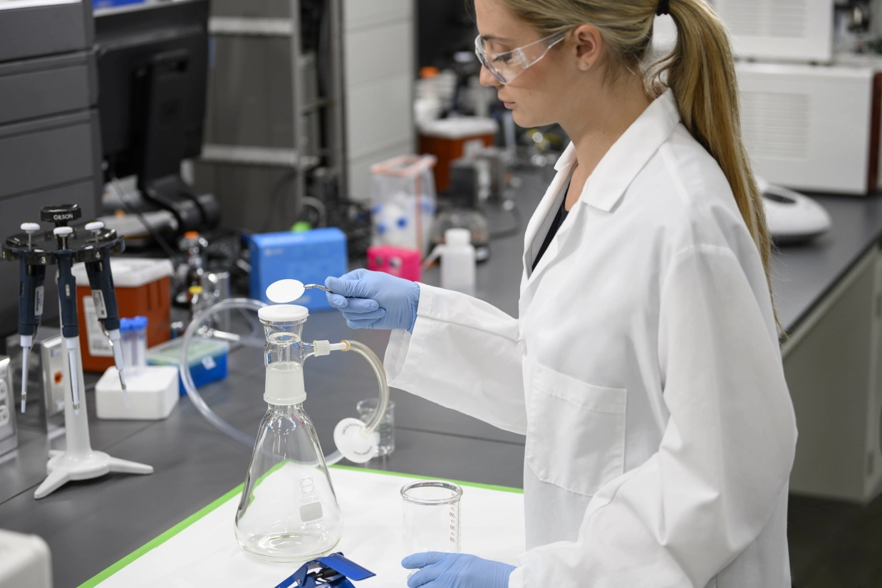 Woman vacuum membrane filtration in lab 3