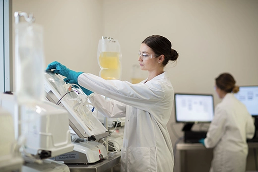 Woman placing a cellbag on a Xuri surrounded by other instruments