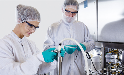 Operators in a cleanroom with AxiChrom anf BioProcess equipment.