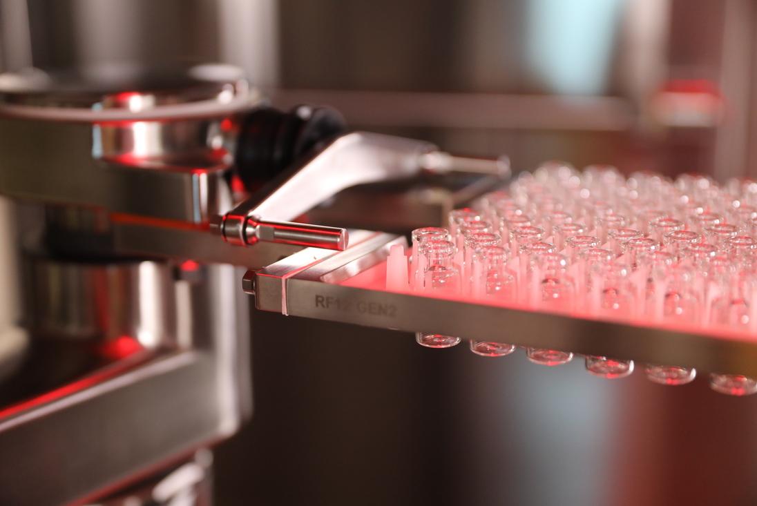 Close-up shot of vials moving through the SA25 Aseptic Filling Workcell