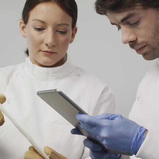 Two scientists reviewing Chronicle interface on iPad