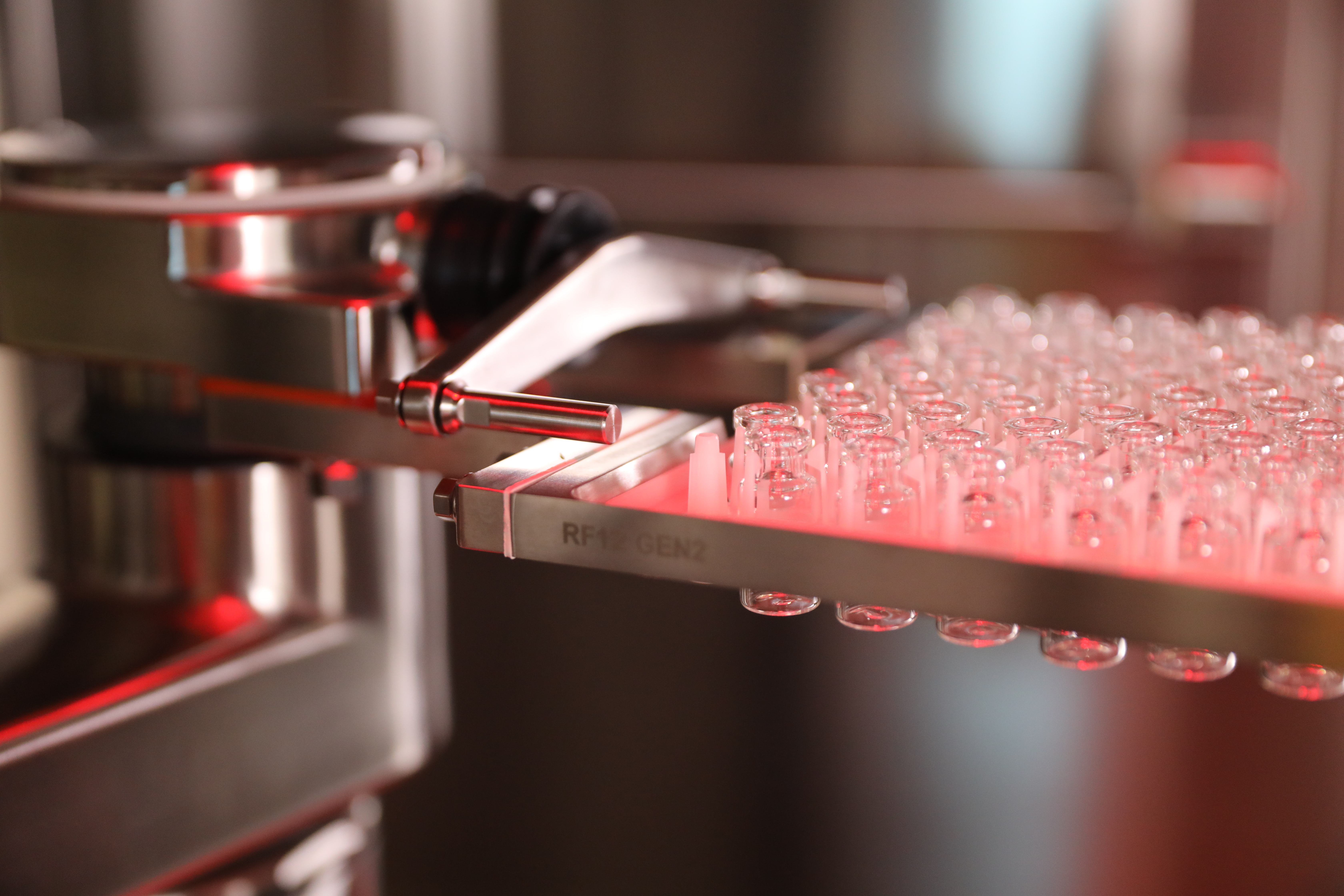 Close-up shot of vials moving through the SA25 aseptic filling workcell